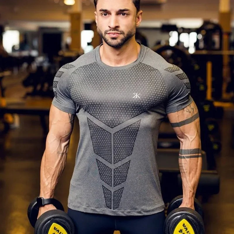 Man lifting weights in a gray quick dry tight fit sports T-shirt, showcasing active lifestyle and fitness training.