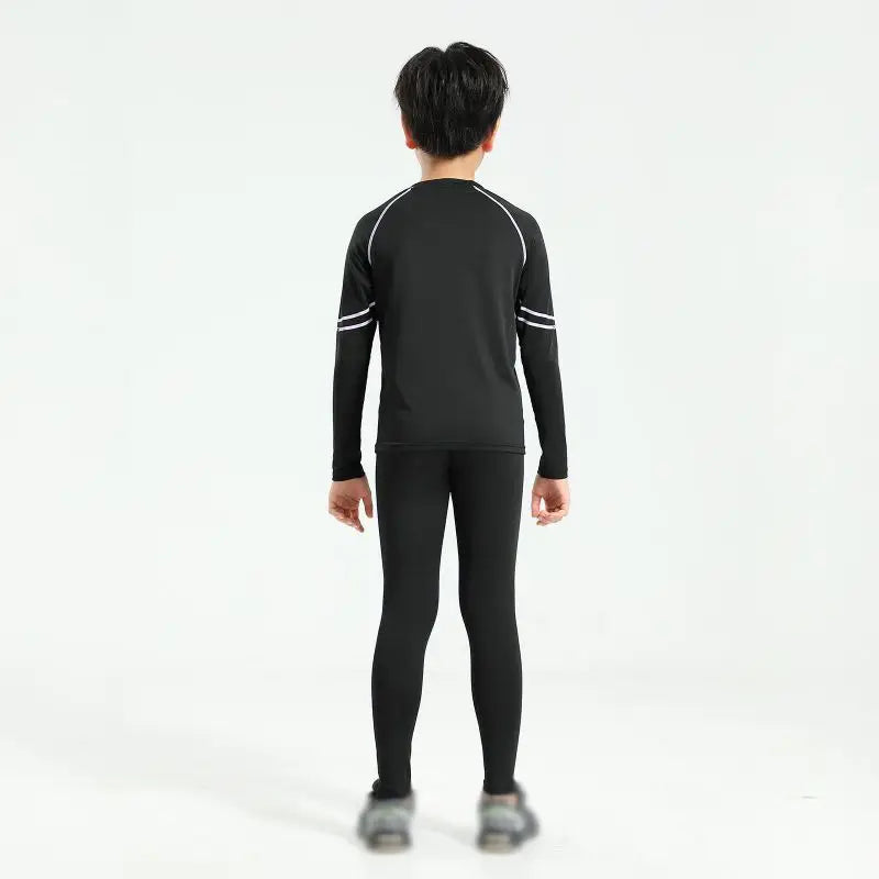 Young boy wearing black thermal compression sportswear set from Aolikes, designed for basketball and soccer.
