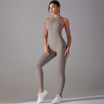 Women's bodysuit in gray, featuring a zip front and fitted design, perfect for fitness and yoga workouts.