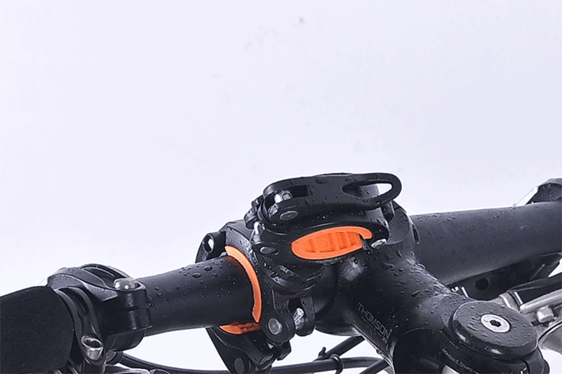 Close-up of WEST BIKING 360° rotatable bike light bracket mounted on a handlebar, showcasing waterproof design.