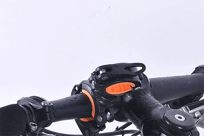 Close-up of WEST BIKING 360° rotatable bike light bracket mounted on a handlebar, showcasing waterproof design.