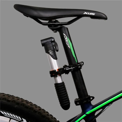 Bicycle seat post with a mounted mini air pump, showcasing practical cycling gear for outdoor enthusiasts.