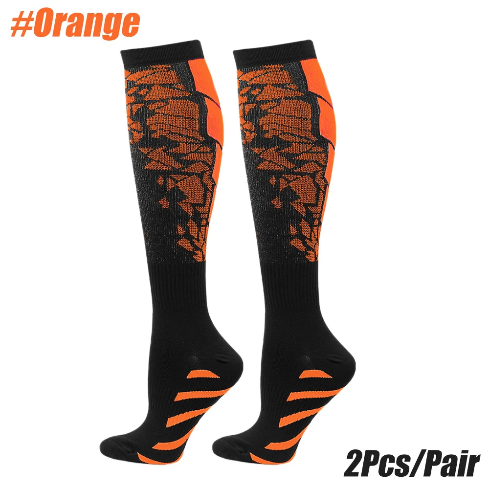 Compression socks in orange and black for men and women, designed for calf support during running and exercise.