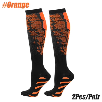 Compression socks in orange and black for men and women, designed for calf support during running and exercise.