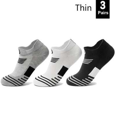 Three pairs of thin, breathable athletic socks in gray, white, and black, designed for sports and everyday wear.