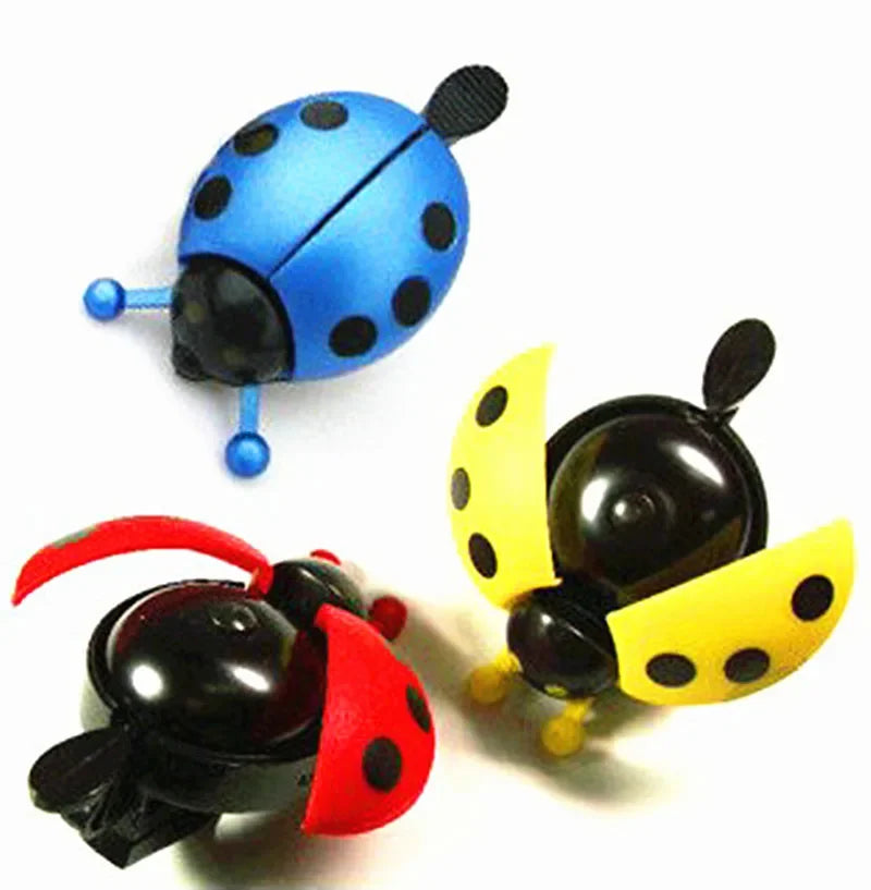 Colorful cartoon ladybug bike bells in blue, red, and yellow for kids' bicycles, adding a fun touch to any ride.