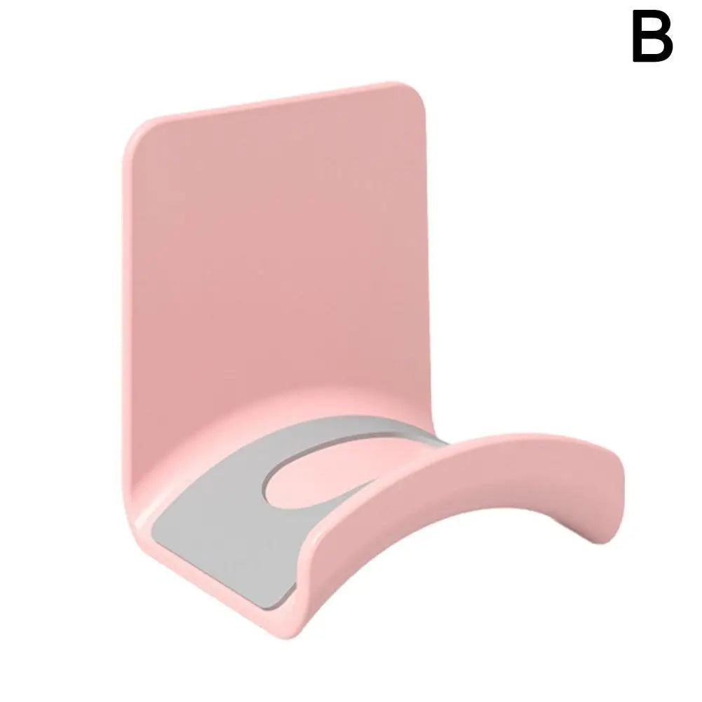 Universal headphone stand in pink, adhesive wall mount for under desk storage of gaming earphones.