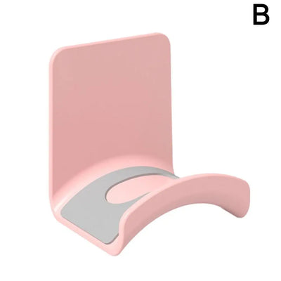Universal headphone stand in pink, adhesive wall mount for under desk storage of gaming earphones.