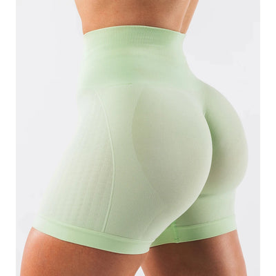 Women wearing seamless high-waisted mint green contour shorts for yoga and fitness workouts.