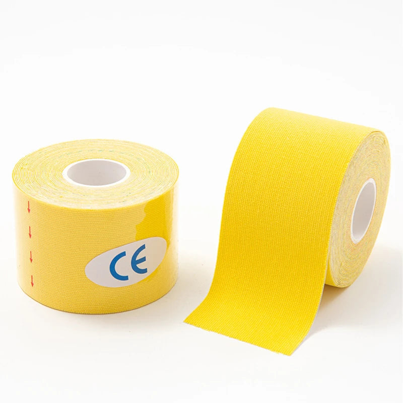 Yellow kinesio tape roll for muscle support and knee pain relief in athletic recovery.