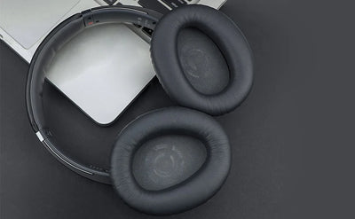 KUTOU replacement ear pads for Sony WH-CH700N CH710N headphones, black leather cushions on a laptop background.