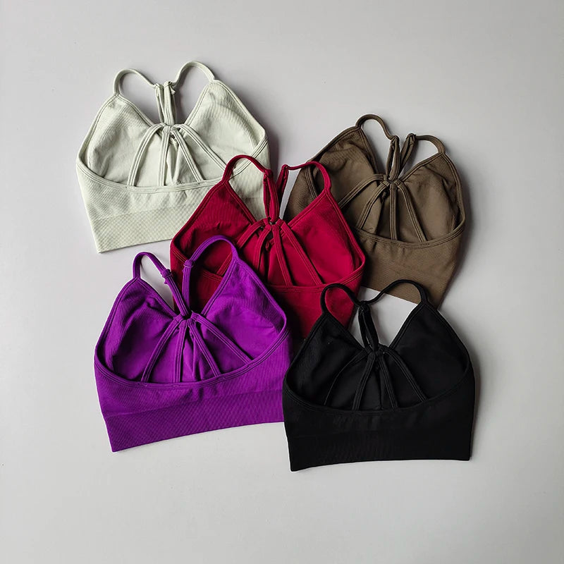 Colorful women's seamless yoga bras in various shades, perfect for fitness and toning workouts.