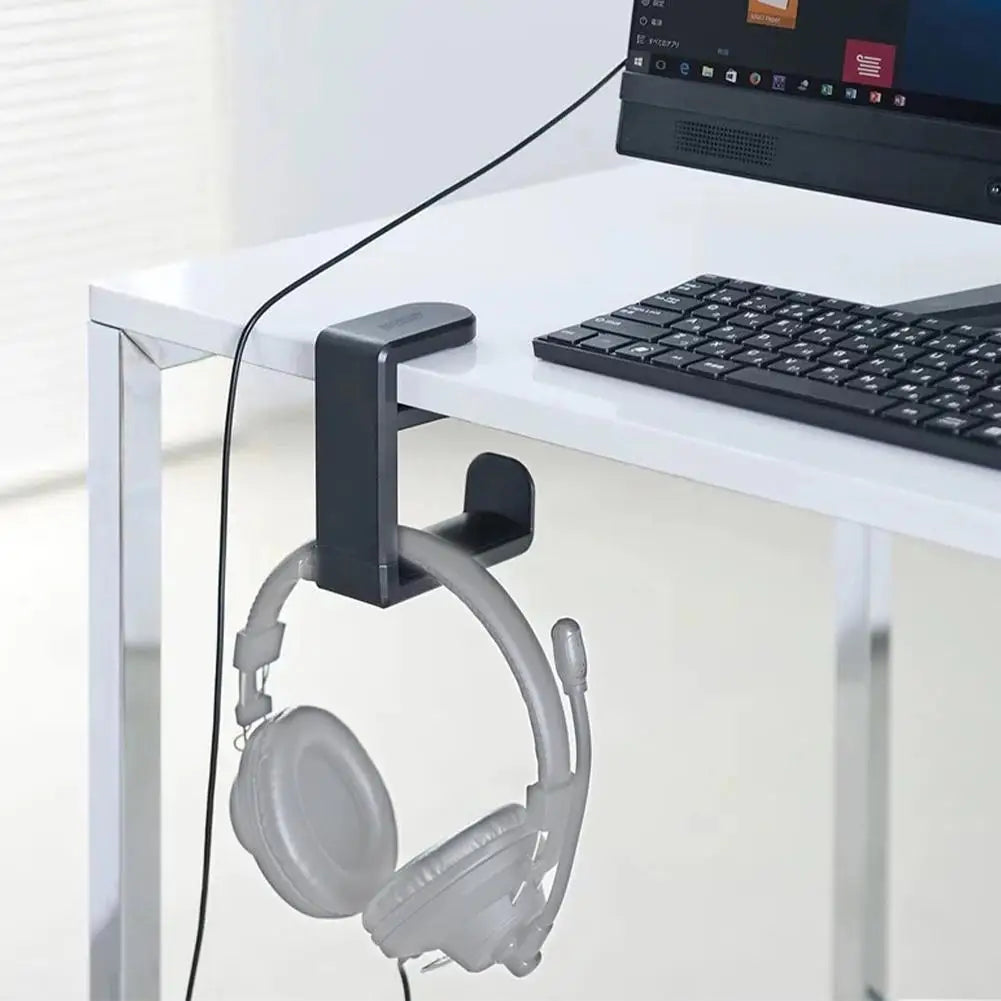 PC gaming headphone stand holder with adjustable 360° rotating arm clamp mounted on a desk.