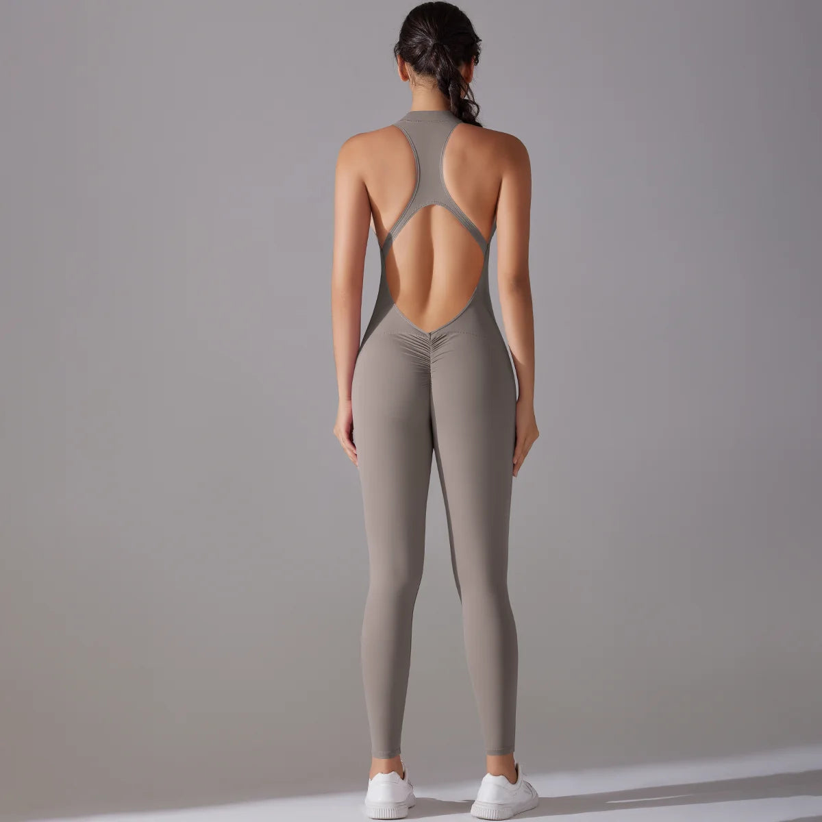 Women's grey bodysuit with back cutout design, perfect for yoga and gym workouts, showcasing tummy control and butt lifting features.