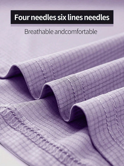Close-up of breathable fabric showcasing four needles six lines stitching, highlighting comfort and quality for athletic wear.