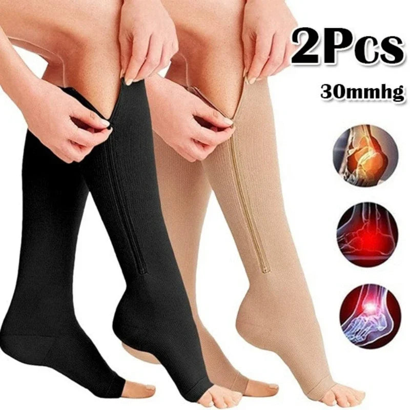 Two pairs of medical compression socks in black and beige, designed for edema and varicose veins, featuring zip closure.