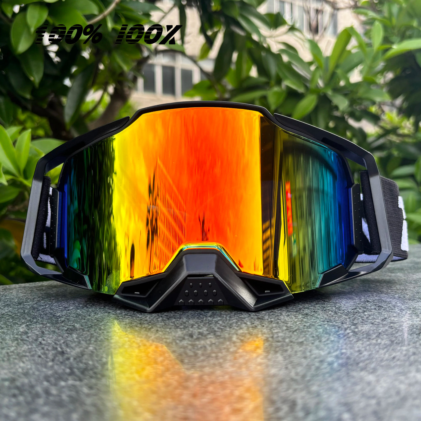 100% IOOX motorcycle goggles with colorful reflective lenses, ideal for off-road MTB cycling and dirt bike racing.