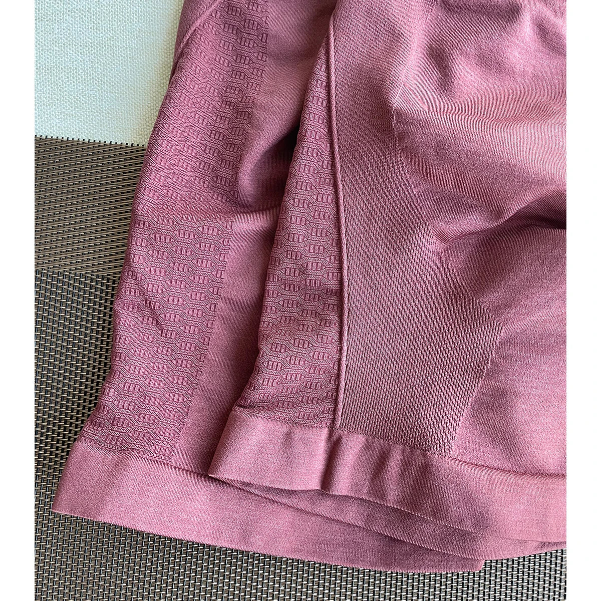 Close-up of Amplify Contour Shorts in pink, showcasing seamless design and textured fabric, ideal for women’s workout and yoga.