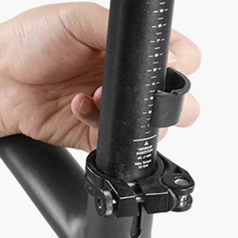 Hand adjusting the height of a bicycle seat post with a quick-release clamp for optimal riding comfort.