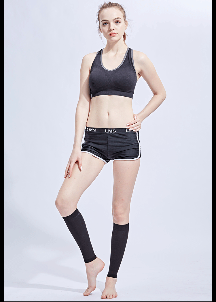 Model showcasing footless compression calf sleeves with sportswear, ideal for fitness and medical support.