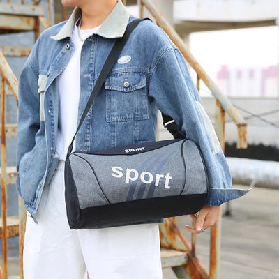 Stylish grey gym bag worn over the shoulder, perfect for sports, travel, and fitness activities.
