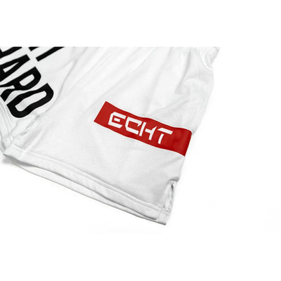 Close-up of men's breathable gym shorts featuring a red logo patch and quick-dry mesh fabric for optimal comfort.