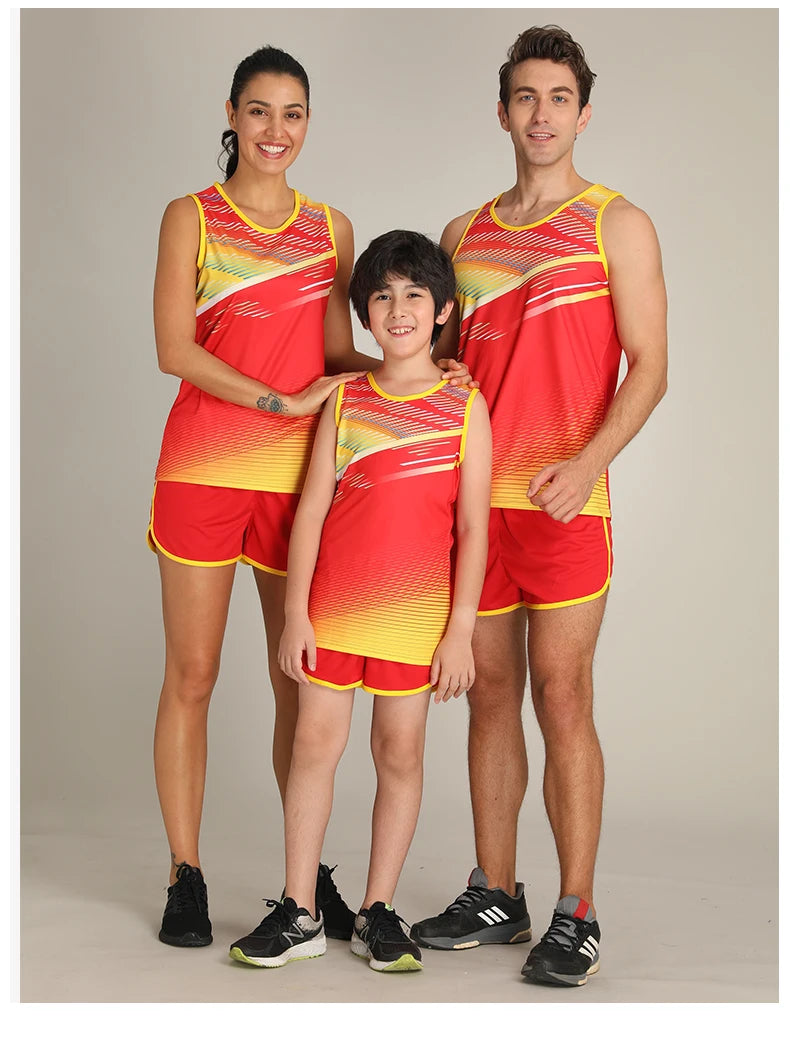 Family wearing custom unisex marathon running suit in vibrant red and yellow, perfect for track and field sports.