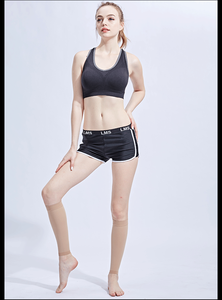 Model wearing compression footless calf socks with black athletic wear, showcasing comfort and style for active use.