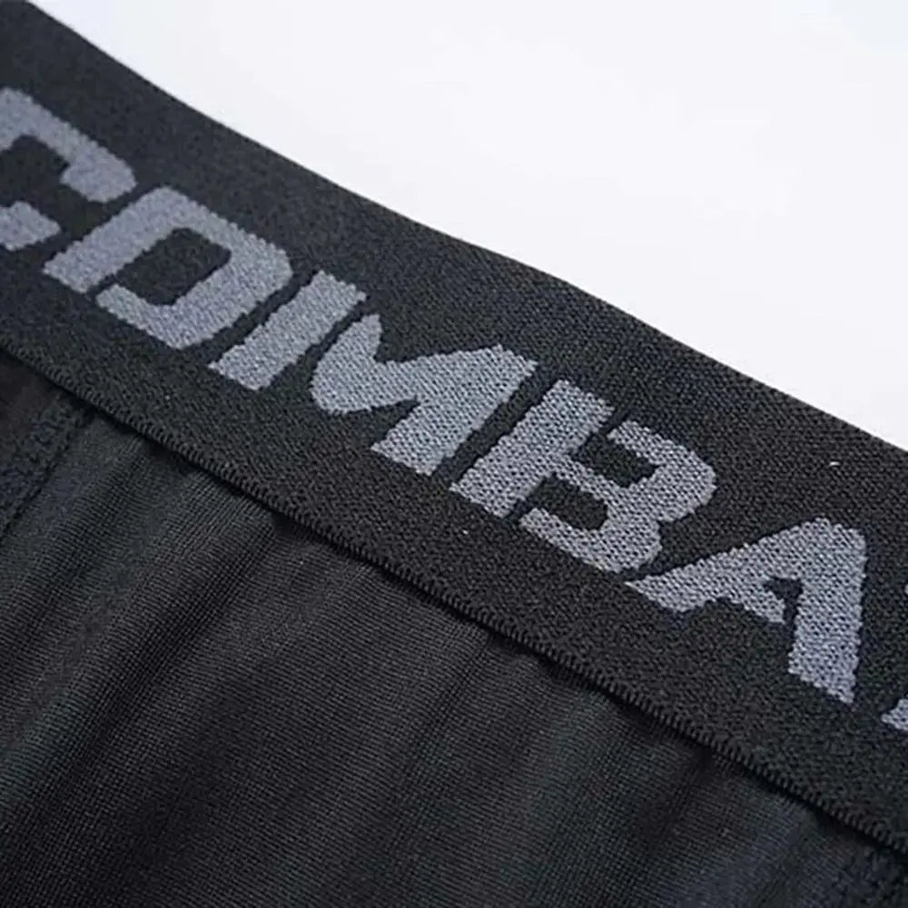 Close-up of the waistband of men's compression shorts featuring 'COMBAT' branding, ideal for athletic performance.