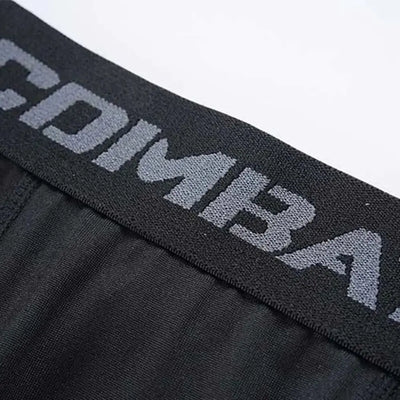 Close-up of the waistband of men's compression shorts featuring 'COMBAT' branding, ideal for athletic performance.