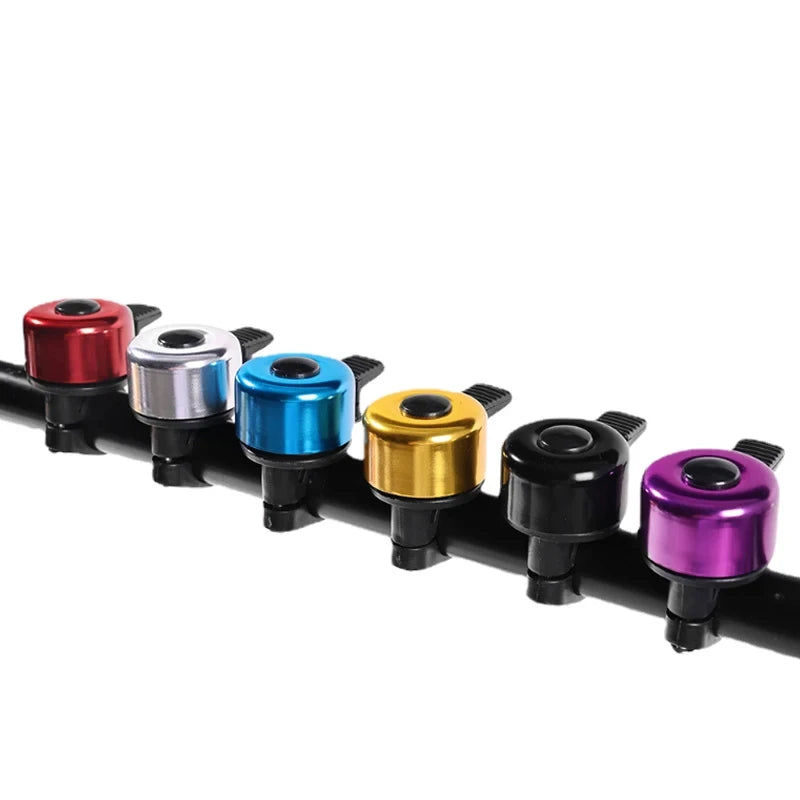 Colorful aluminum alloy MTB bicycle bells on handlebars for safety, featuring red, blue, silver, gold, black, and purple options.