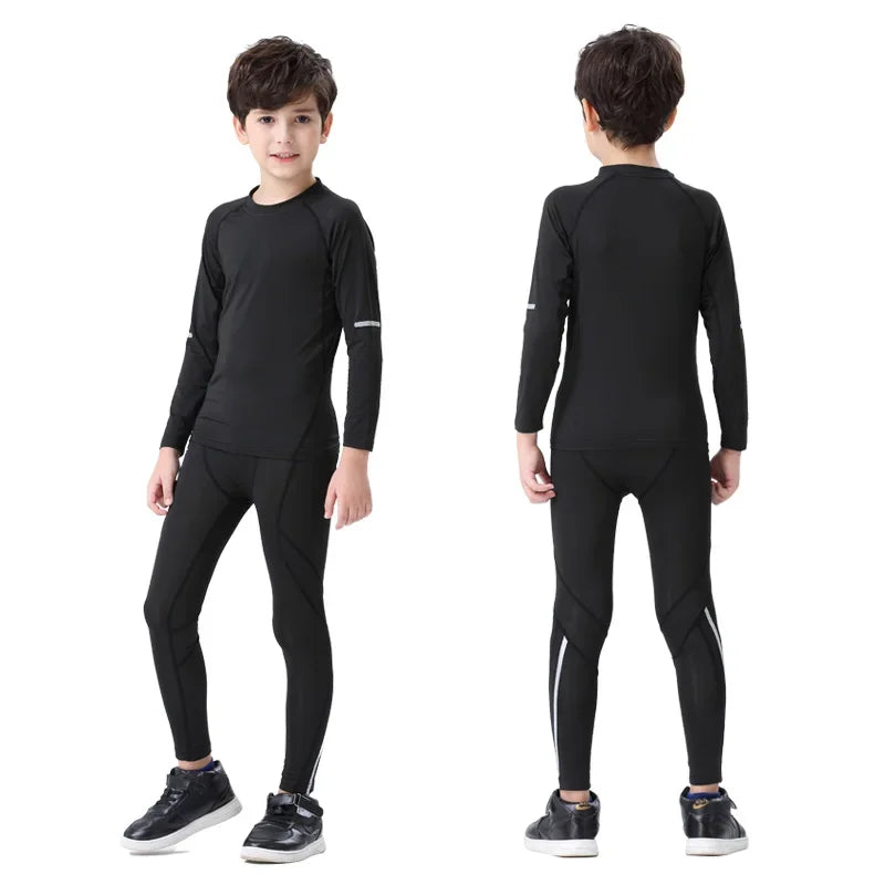 Boys wearing black thermal sports set, including compression tights and long-sleeve top for winter running.