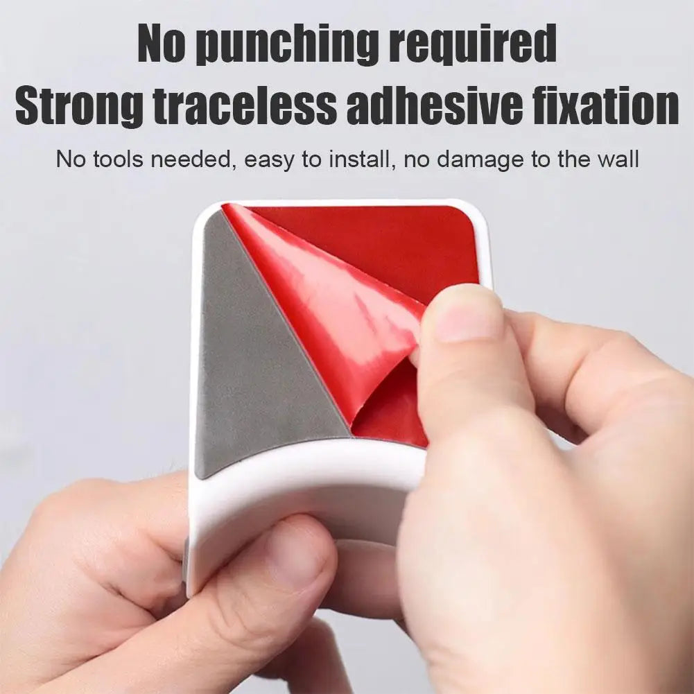 Hands peeling adhesive from a universal headphone stand, showcasing easy installation without wall damage.