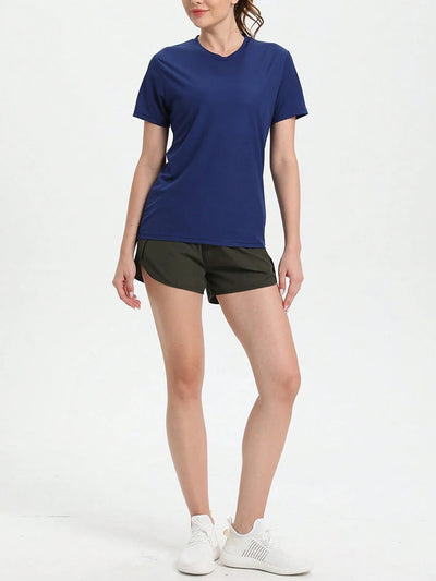 Model wearing women's solid color ultralight quick dry sport t-shirt with shorts, ideal for running and gym activities.
