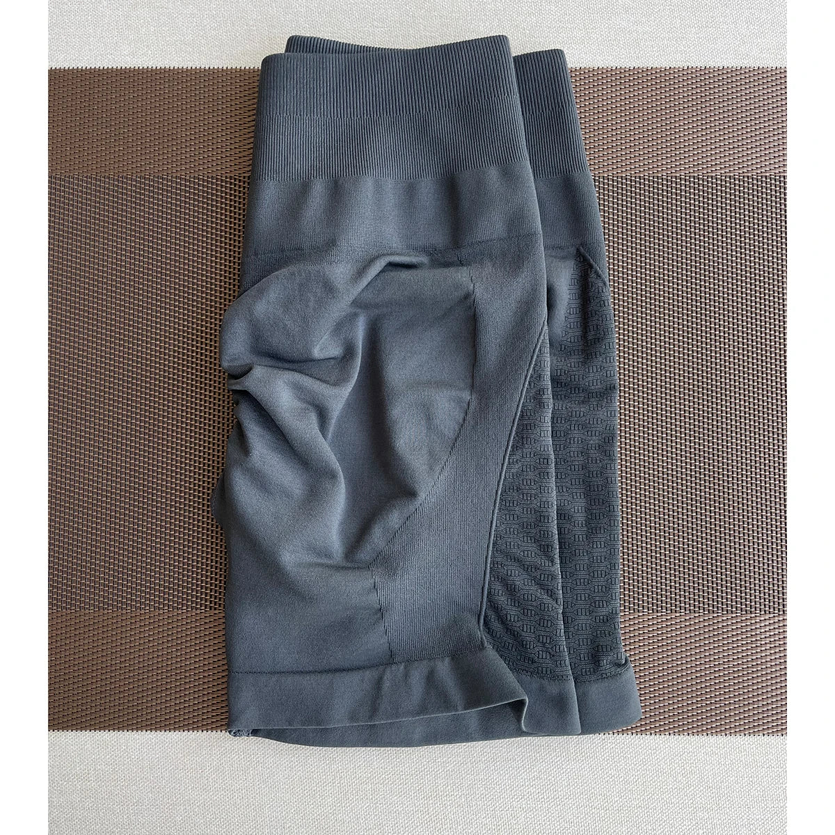 Gray women's contour shorts made from nylon and spandex, ideal for yoga and gym workouts.