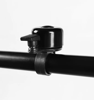 Aluminum alloy bicycle bell mounted on a black handlebar for enhanced safety and loud sound.