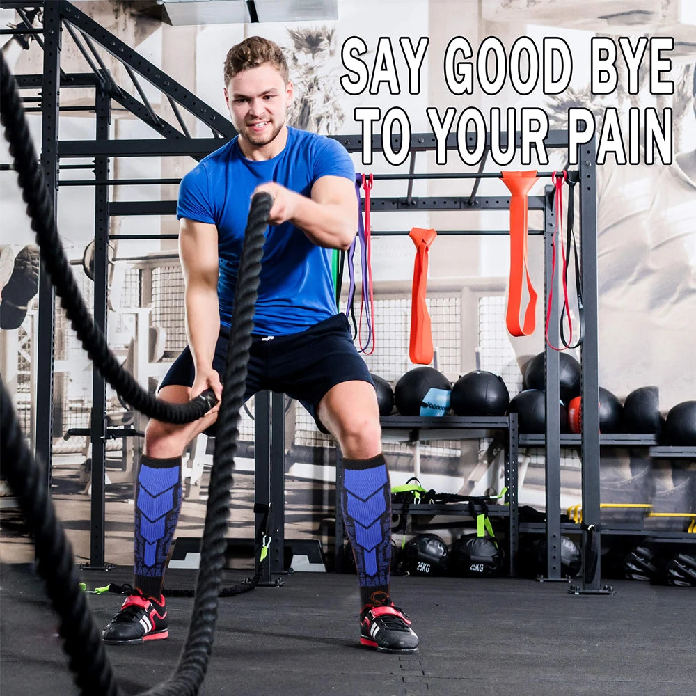 Man in compression socks exercising with battle ropes in gym, promoting calf support and pain relief.