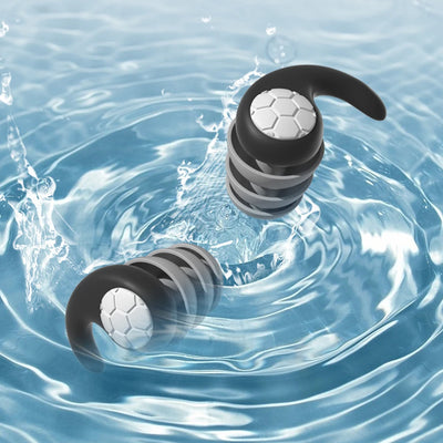 Silicone earplugs floating in water, designed for swimming, noise reduction, and comfortable sleep.