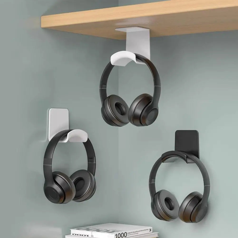 Universal headphone stand adhesive wall mount for under desk, sleek design holding three gaming headsets.