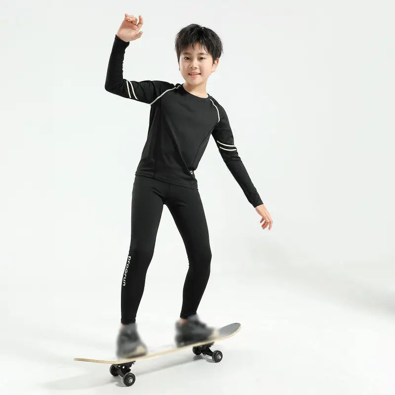 Boys' thermal compression sportswear set, ideal for basketball and soccer, featured on a young skater.