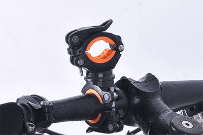 Close-up of the WEST BIKING 360° rotating bike light bracket mounted on a handlebars, showcasing its waterproof design.