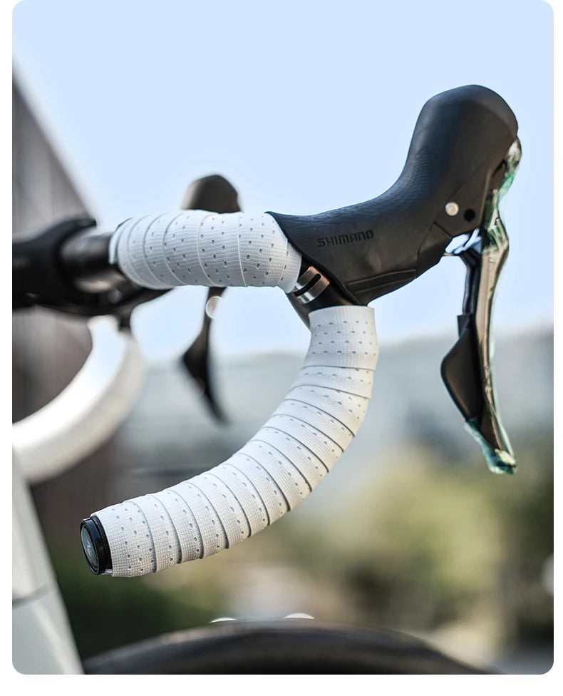 Close-up of white soft grip bicycle handlebar tape on a bike. Non-slip and lightweight for better control.