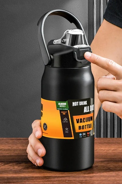 Stainless steel vacuum thermos bottle with a convenient handle and straw, perfect for hot and cold drinks.
