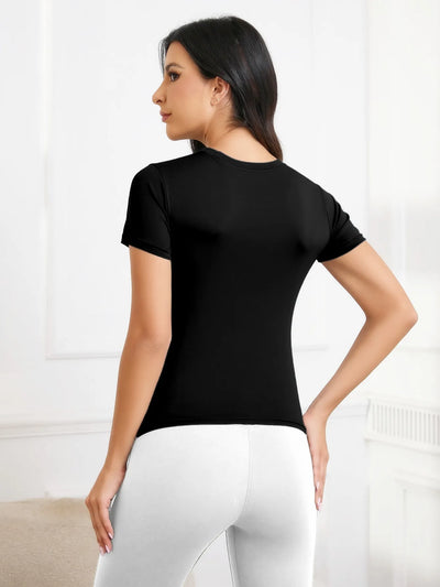Woman wearing a black short sleeve workout shirt, showcasing the back view in a bright indoor setting.